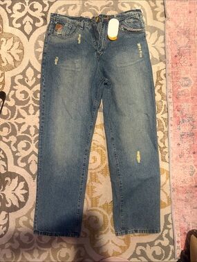 Akademiks Orange and Gray Brand Hang Tag on Denim